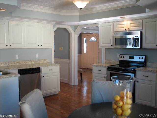 12011 Taplow Road Midlothian, VA 23112 - Photo 6 of 12 a kitchen with stainless steel appliances granite countertop a stove a sink and a refrigerator