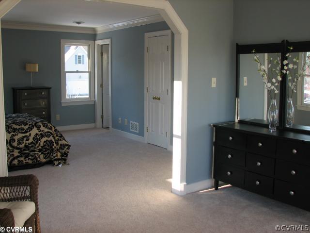 12011 Taplow Road Midlothian, VA 23112 - Photo 9 of 12 a bedroom with a bed and a dresser