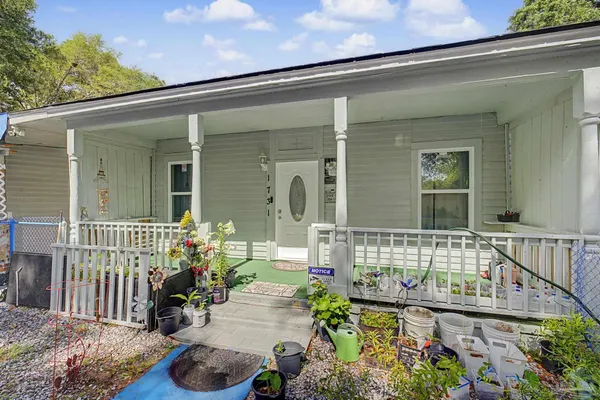 a front view of a house with outdoor seating
