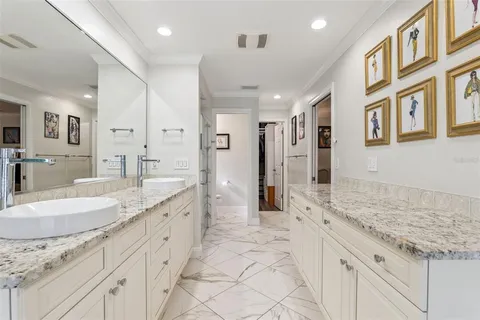 a bathroom with a granite countertop shower and a sink