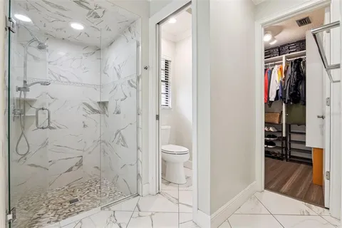 a bathroom with a granite countertop sink and a bathtub