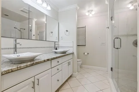 a spacious bathroom with a granite countertop sink mirror and shower