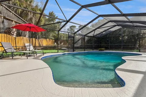 a living room with furniture a rug and a large window