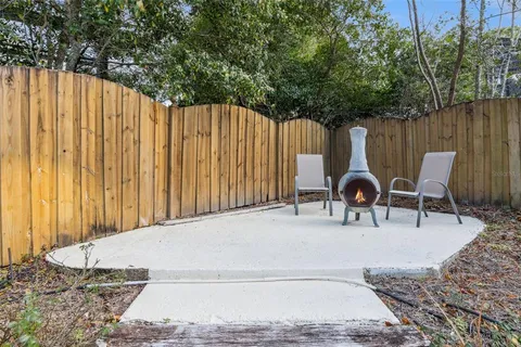 a view of backyard with swimming pool and outdoor seating