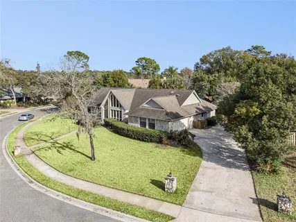 an aerial view of residential houses with outdoor space and parking