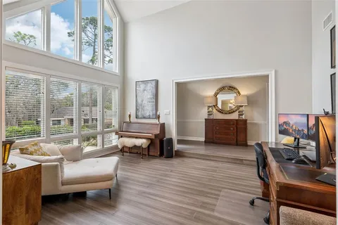 a living room with furniture and a flat screen tv with wooden floor