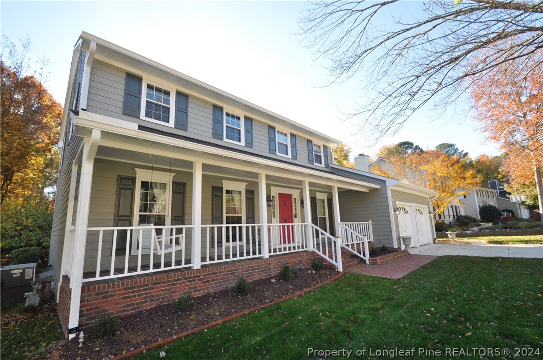 a view of a house with a yard and deck