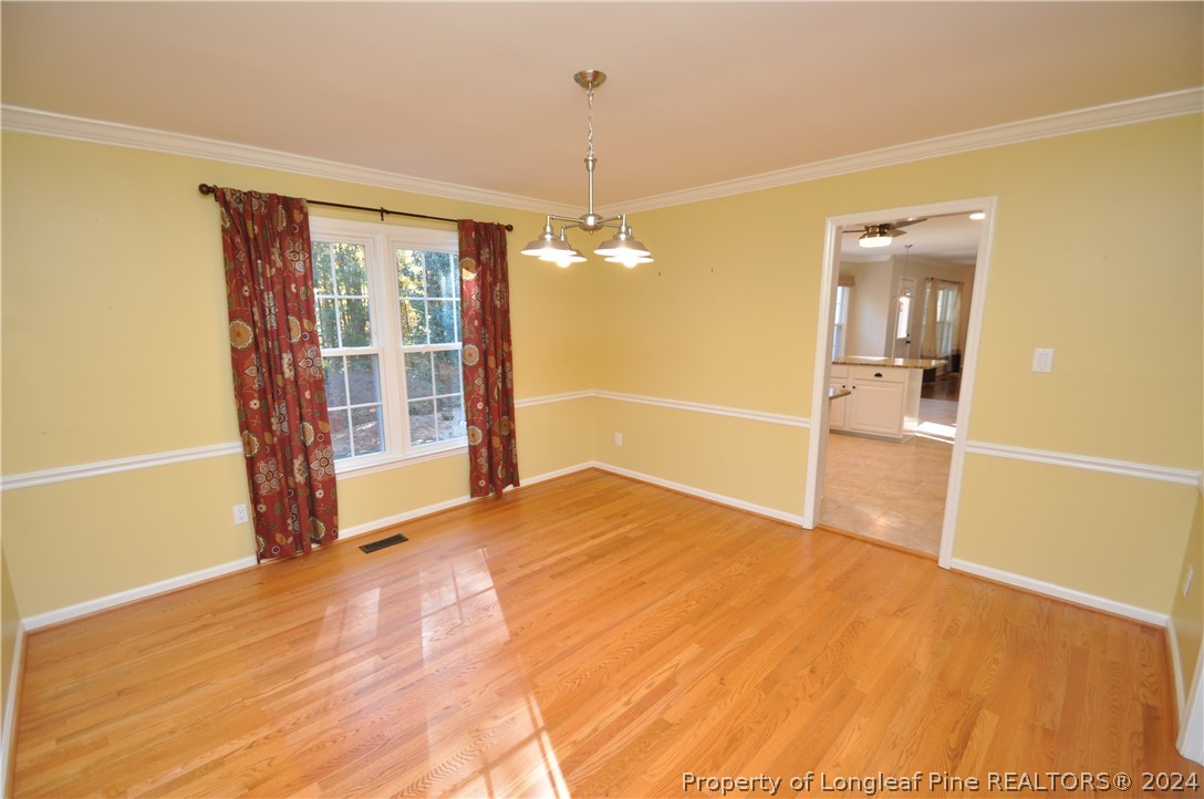 Undisclosed Address Cary, NC 27513 - Photo 11 of 50 a view of an empty room with wooden floor and a window