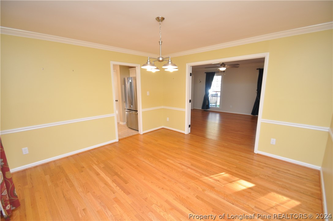 Undisclosed Address Cary, NC 27513 - Photo 12 of 50 a view of an empty room with window and wooden floor