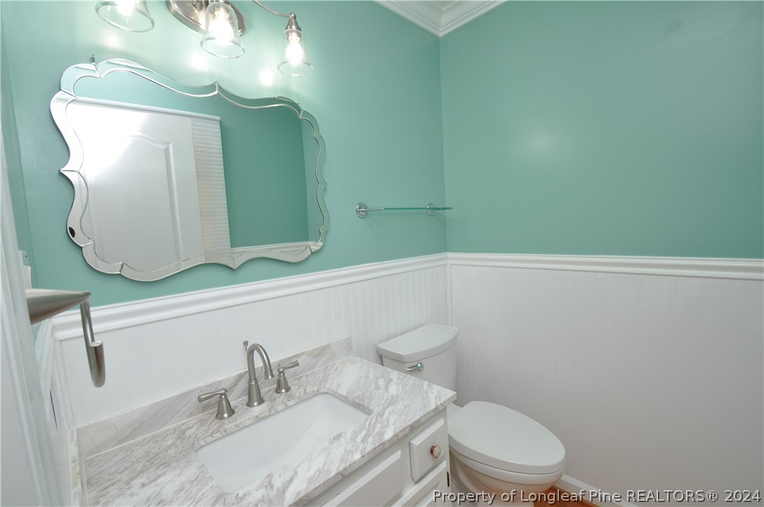 Undisclosed Address Cary, NC 27513 - Photo 13 of 50 a bathroom with a granite countertop sink vanity mirror and toilet