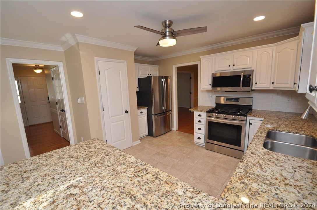 Undisclosed Address Cary, NC 27513 - Photo 16 of 50 a kitchen with a stove and a refrigerator