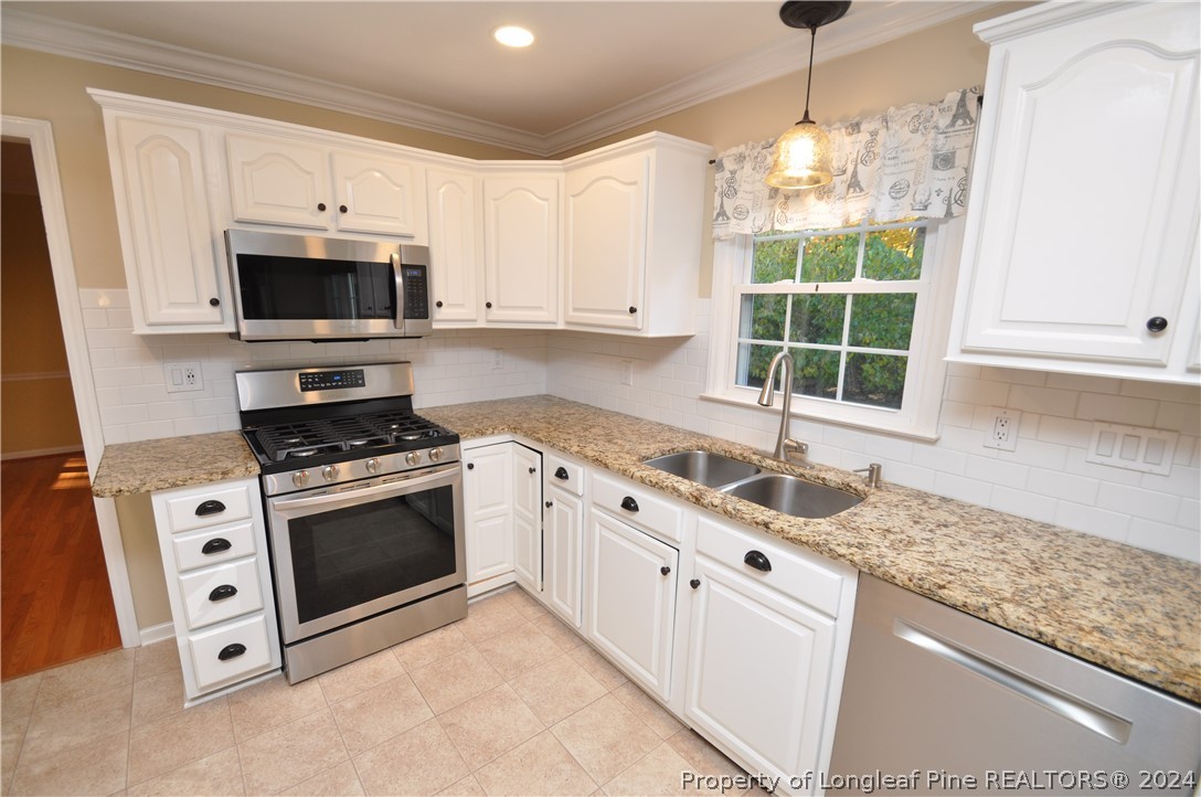 Undisclosed Address Cary, NC 27513 - Photo 19 of 50 a kitchen with granite countertop a sink stainless steel appliances and cabinets