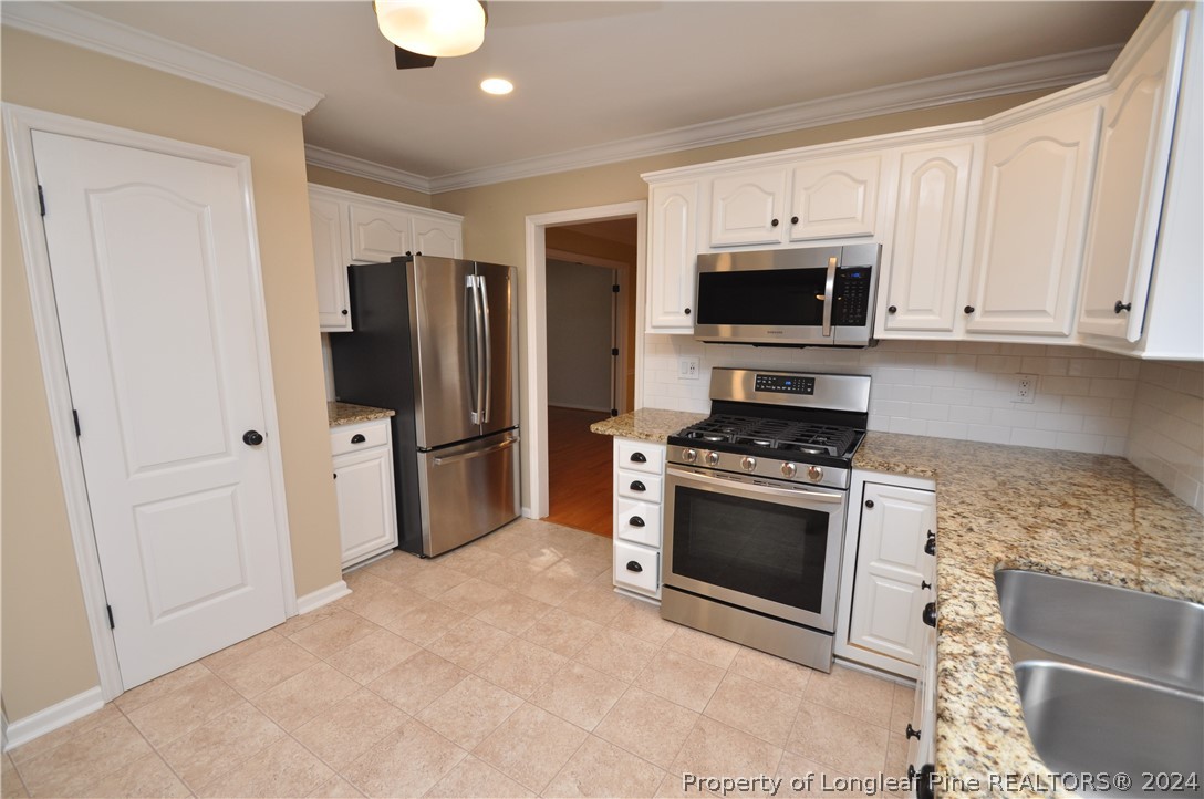 Undisclosed Address Cary, NC 27513 - Photo 20 of 50 a kitchen with stainless steel appliances granite countertop a stove a refrigerator and a sink