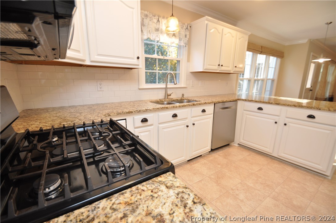 Undisclosed Address Cary, NC 27513 - Photo 22 of 50 a kitchen with a stove a window and cabinets