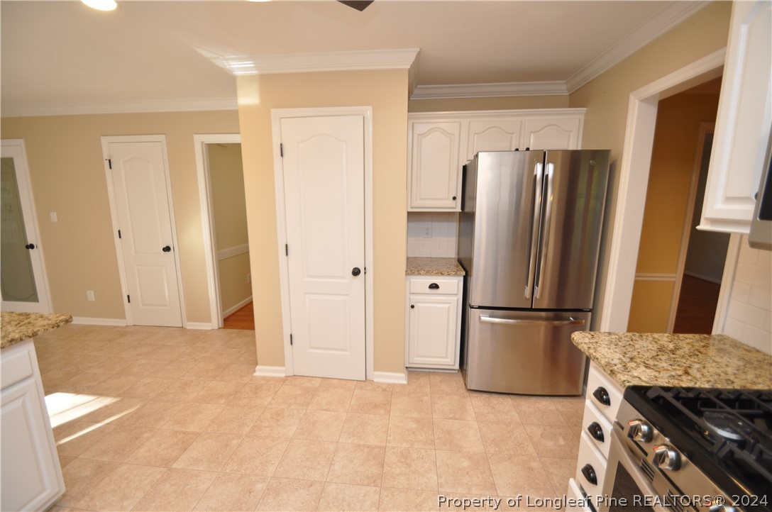 Undisclosed Address Cary, NC 27513 - Photo 23 of 50 a view of kitchen with refrigerator stove and cabinets