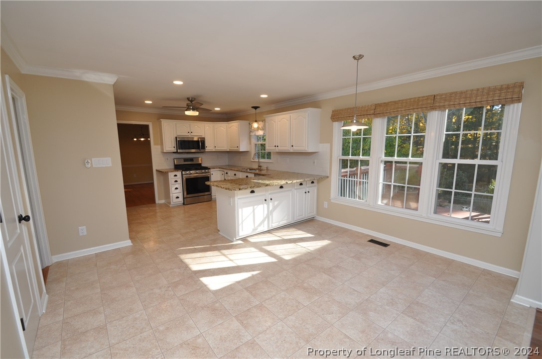 Undisclosed Address Cary, NC 27513 - Photo 26 of 50 a view of kitchen with stainless steel appliances granite countertop lots of counter top space and windows