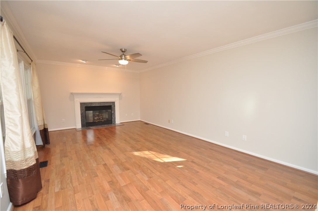 Undisclosed Address Cary, NC 27513 - Photo 29 of 50 wooden floor in an empty room with a fireplace