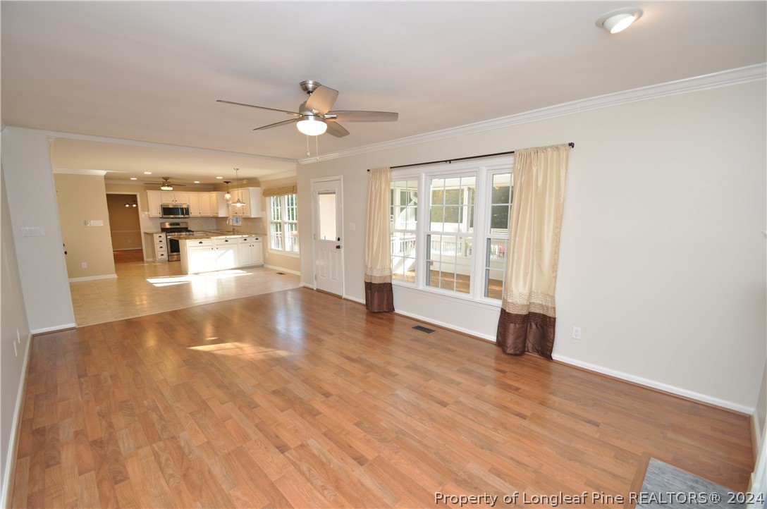 Undisclosed Address Cary, NC 27513 - Photo 30 of 50 a view of an empty room with window and wooden floor