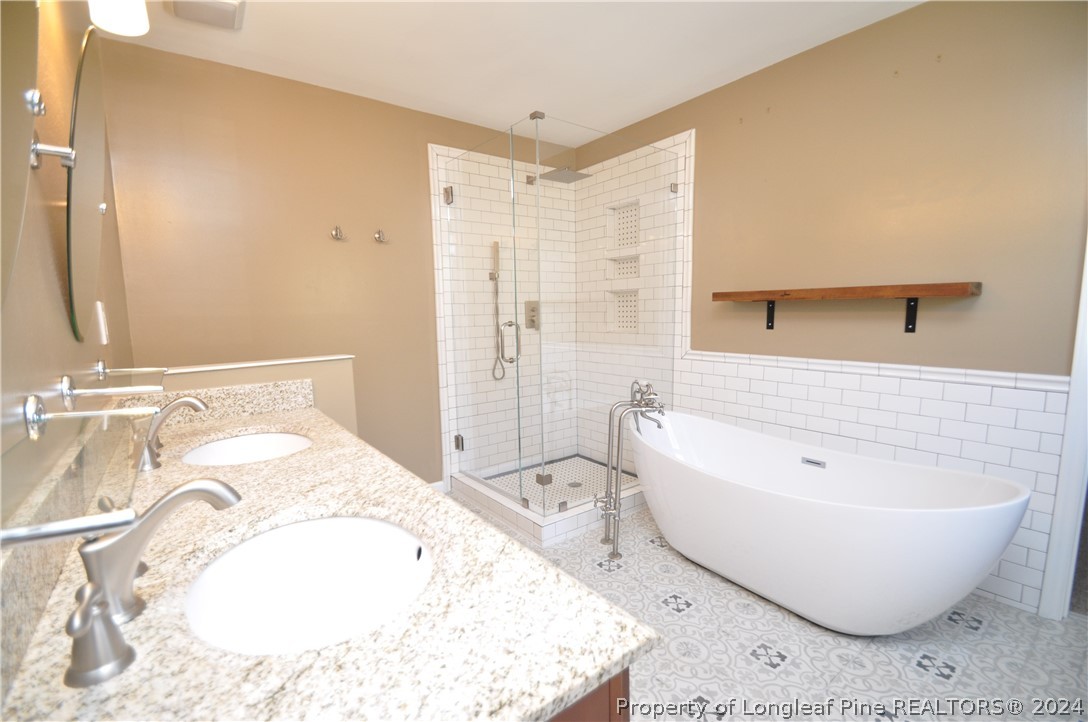 Undisclosed Address Cary, NC 27513 - Photo 35 of 50 a spacious bathroom with a bathtub and sink
