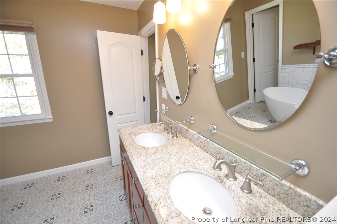 Undisclosed Address Cary, NC 27513 - Photo 36 of 50 a bathroom with a granite countertop sink and a mirror