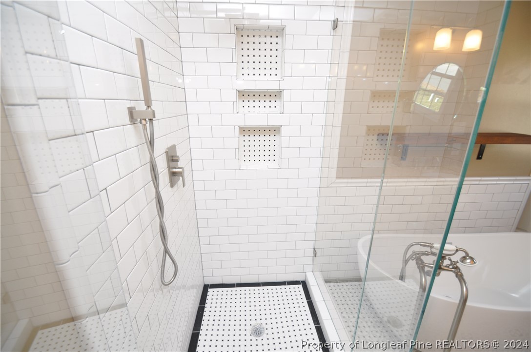 Undisclosed Address Cary, NC 27513 - Photo 38 of 50 a bathroom with a white tub and shower