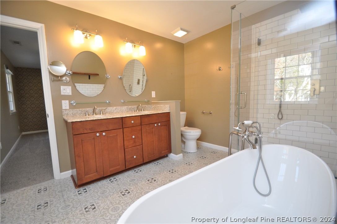 Undisclosed Address Cary, NC 27513 - Photo 39 of 50 a bathroom with a double vanity sink mirror and a shower