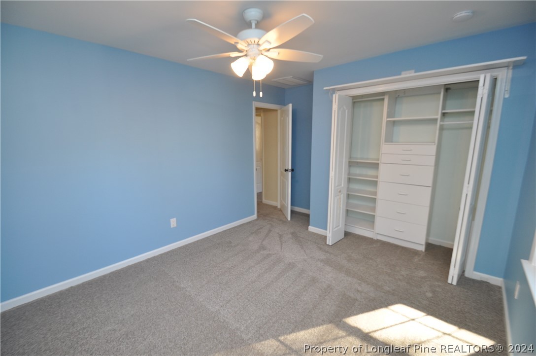 Undisclosed Address Cary, NC 27513 - Photo 43 of 50 an empty room with closet and a chandelier fan