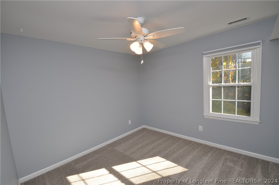 Undisclosed Address Cary, NC 27513 - Photo 44 of 50 an empty room with a window and ceiling fan