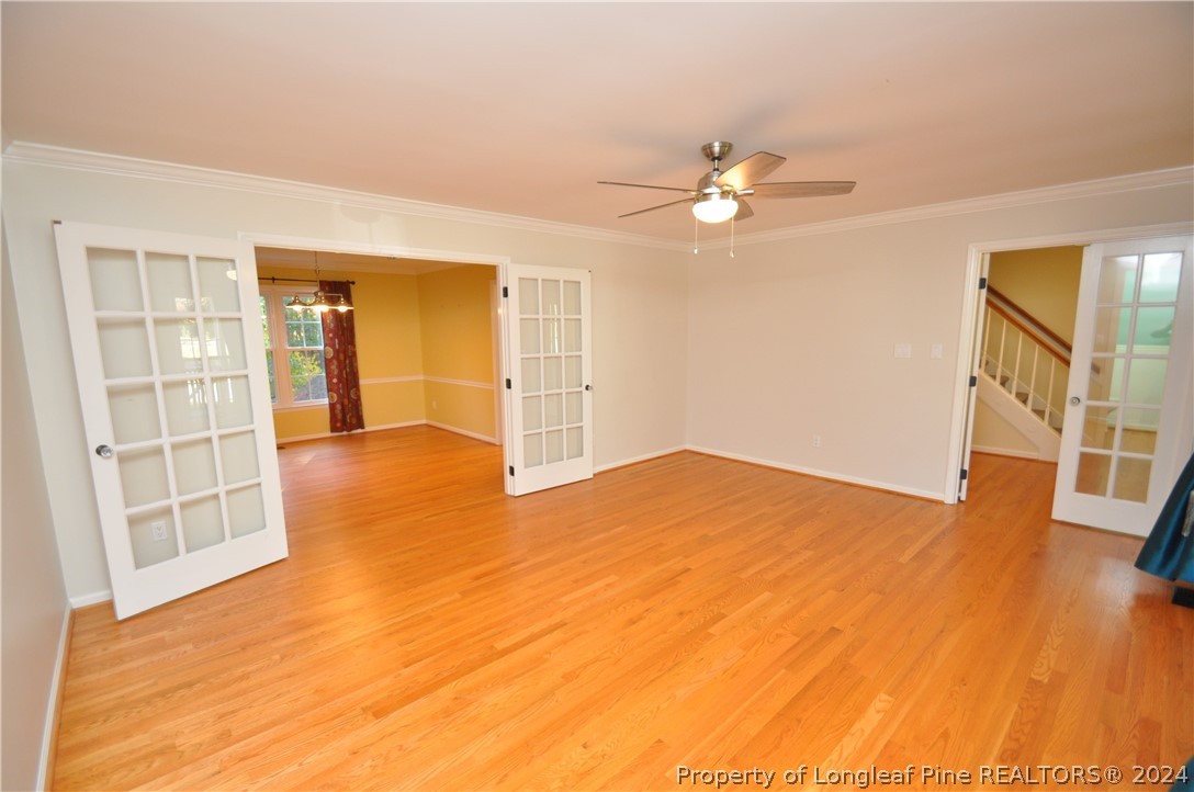 Undisclosed Address Cary, NC 27513 - Photo 10 of 50 a view of empty room with wooden floor and fan