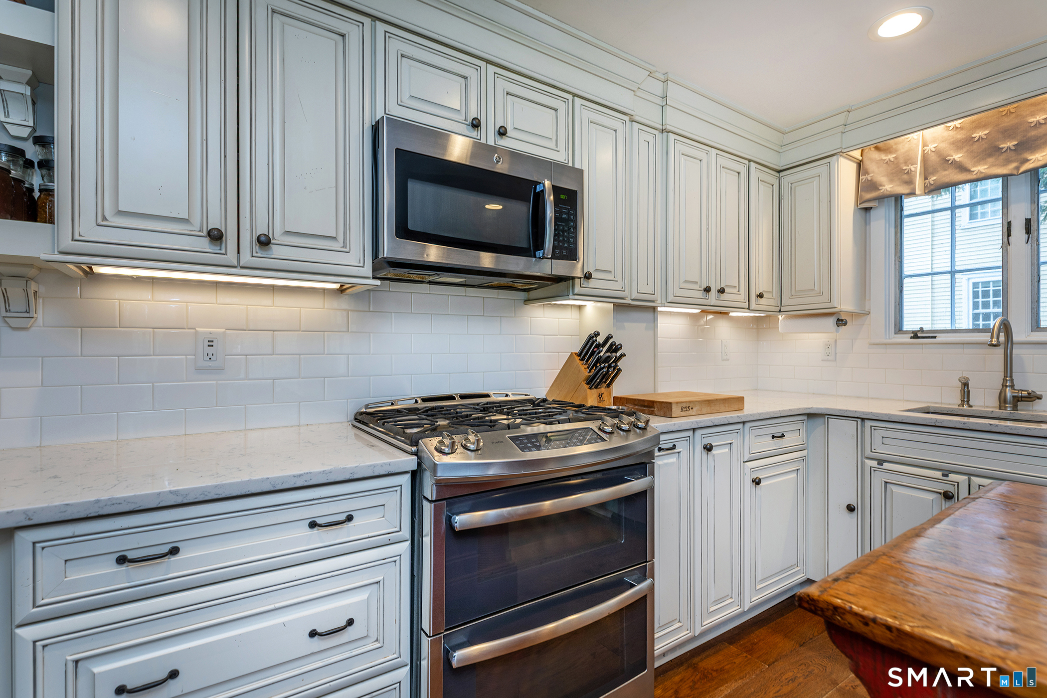 30 Hollow Road Woodbury, CT 06798 - Photo 11 of 40 a kitchen with stainless steel appliances granite countertop a sink a stove and microwave