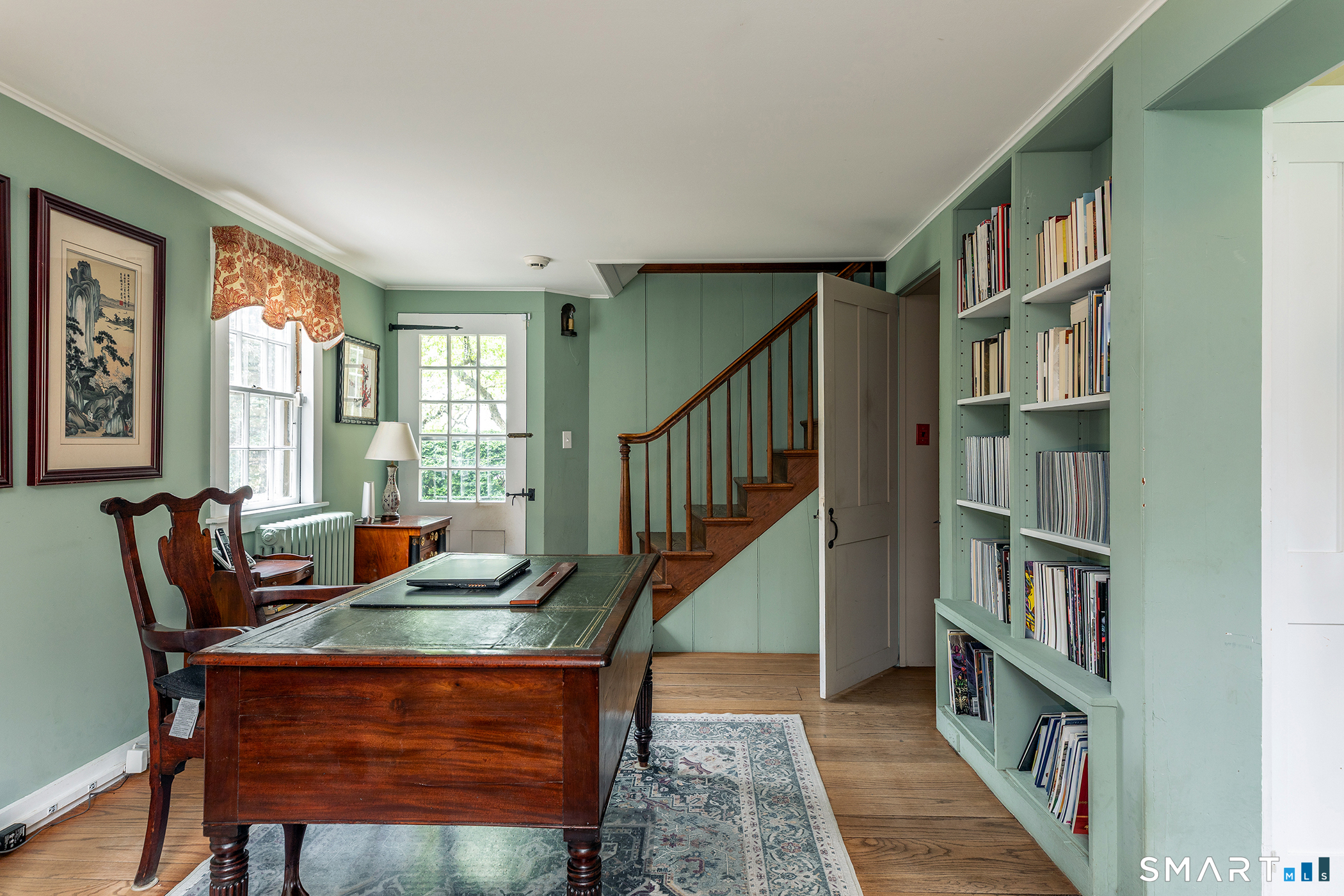 30 Hollow Road Woodbury, CT 06798 - Photo 14 of 40 a living room with furniture a bookshelf and a window