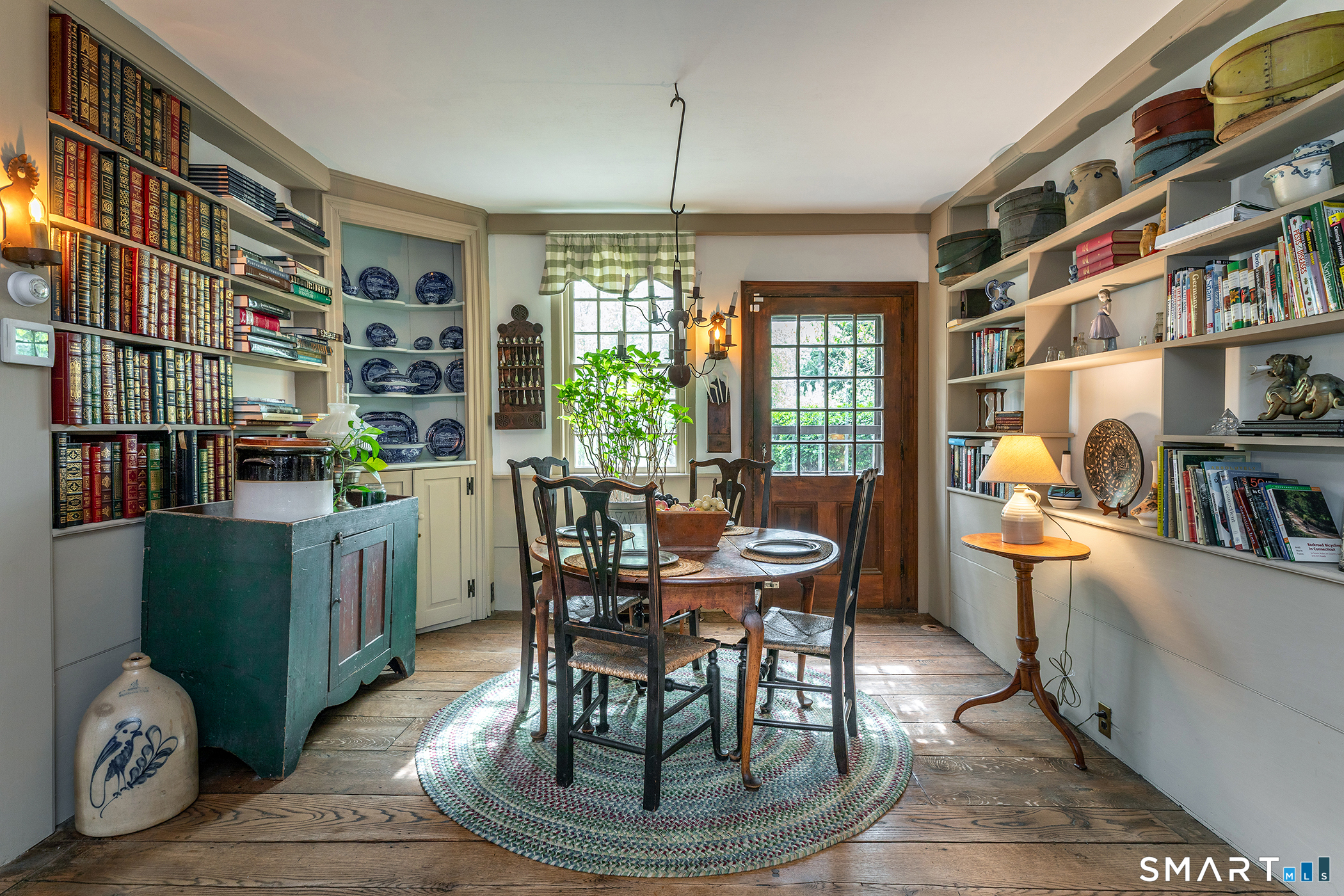 30 Hollow Road Woodbury, CT 06798 - Photo 8 of 40 a dining room with furniture and a book shelf
