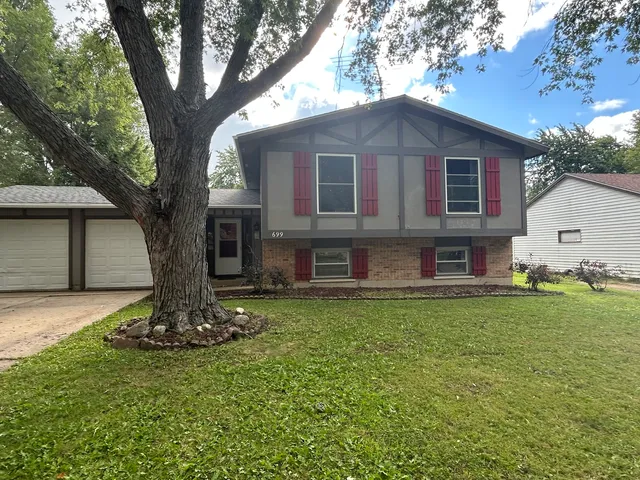 a front view of a house with a garden
