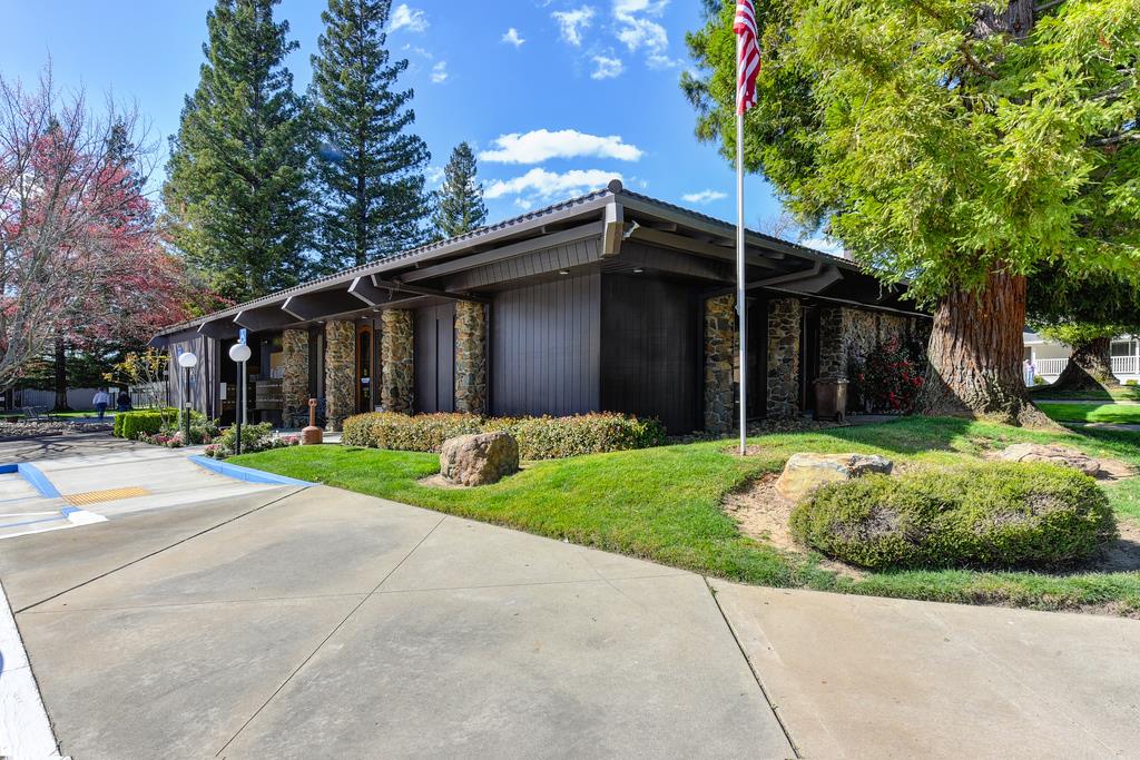 14789 Jurata Court Rancho Murieta, CA 95683 - Photo 18 of 36 a view of brick house with a yard plants and large tree