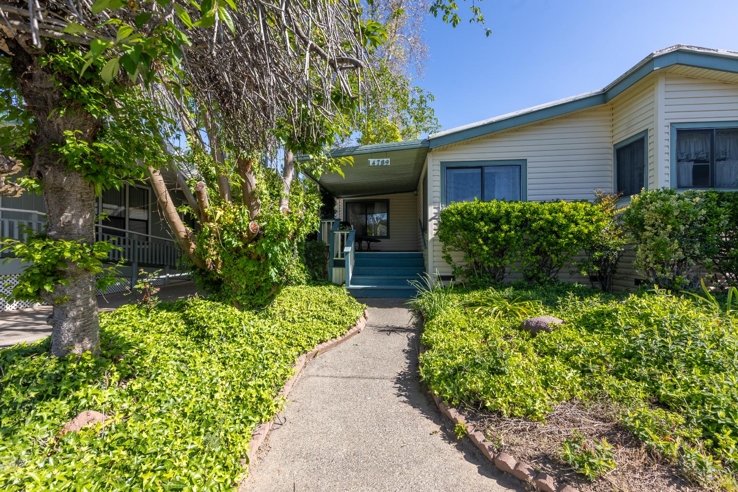 14789 Jurata Court Rancho Murieta, CA 95683 - Photo 2 of 36 a view of a house with potted plants and large trees