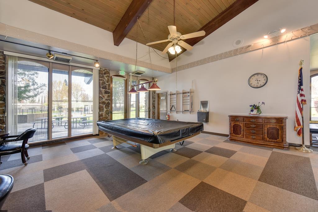 14789 Jurata Court Rancho Murieta, CA 95683 - Photo 24 of 36 a living room with furniture a flat screen tv and a large window