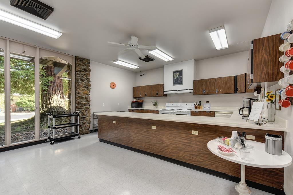 14789 Jurata Court Rancho Murieta, CA 95683 - Photo 25 of 36 a large kitchen with kitchen island granite countertop a sink and a stove