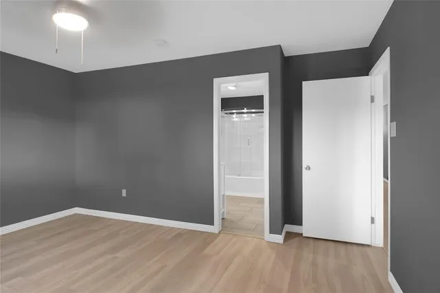 an empty room with wooden floor and closet