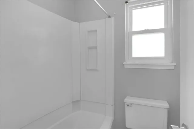 a bathroom with a toilet and a bathtub