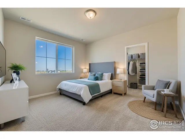 a bedroom with a large bed and a couch