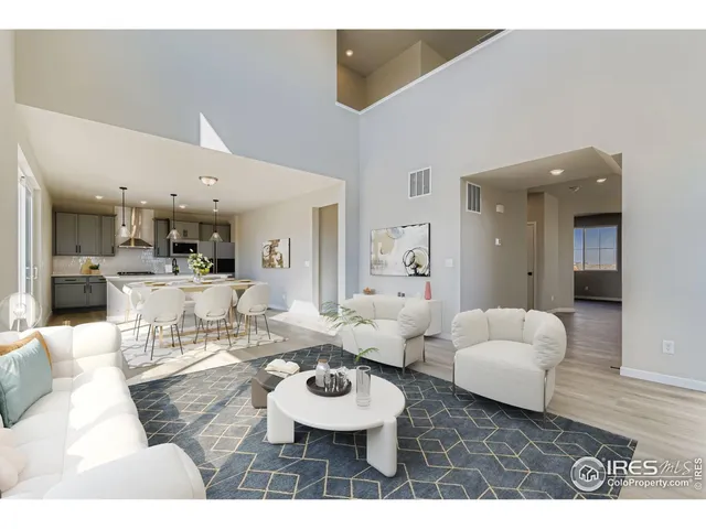 a living room with furniture and kitchen view