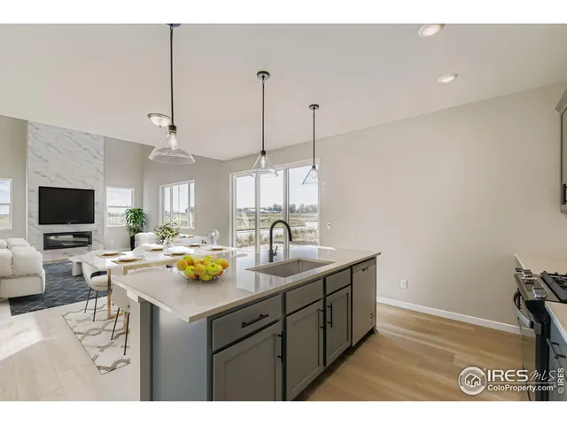a kitchen with a sink a counter space appliances and cabinets