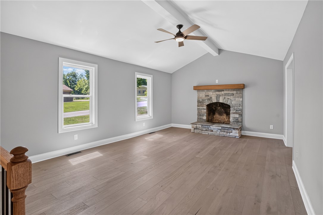 712 Beech Drive Seneca, SC 29678 - Photo 9 of 41 A spacious living area showcasing beautiful hardwood floors and a stone fireplace.