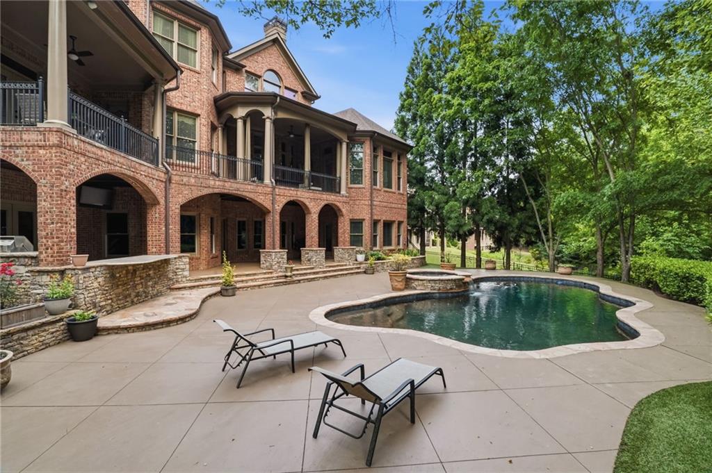 8340 Colonial Place Duluth, GA 30097 - Photo 56 of 74 a view of a swimming pool with a lounge chair
