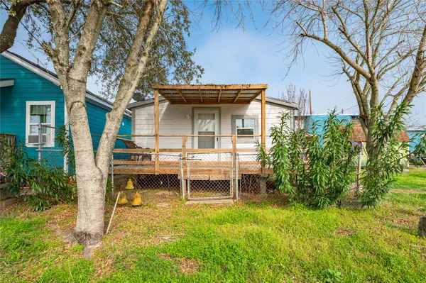 a backyard of a house with table and chairs