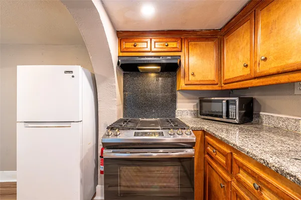 a kitchen with granite countertop cabinets and steel stainless steel appliances