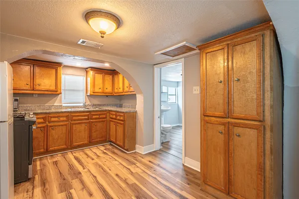 a view of a kitchen with a sink and wooden floor