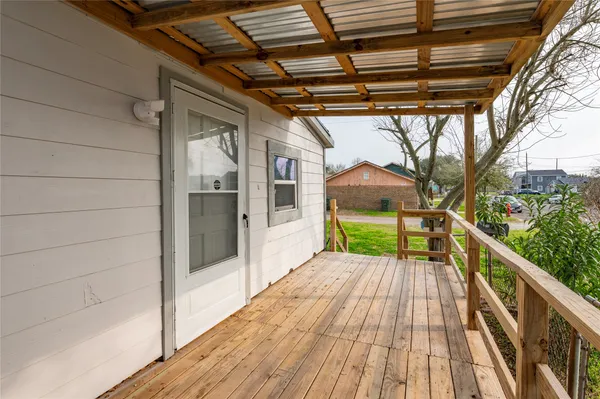 a view of a balcony with wooden floor