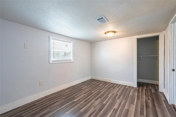 a view of a room with wooden floor