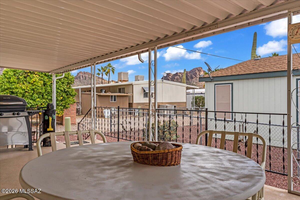 5840 West Flying W Street Tucson, AZ 85713 - Photo 2 of 38 a roof deck with a table and chairs and potted plants